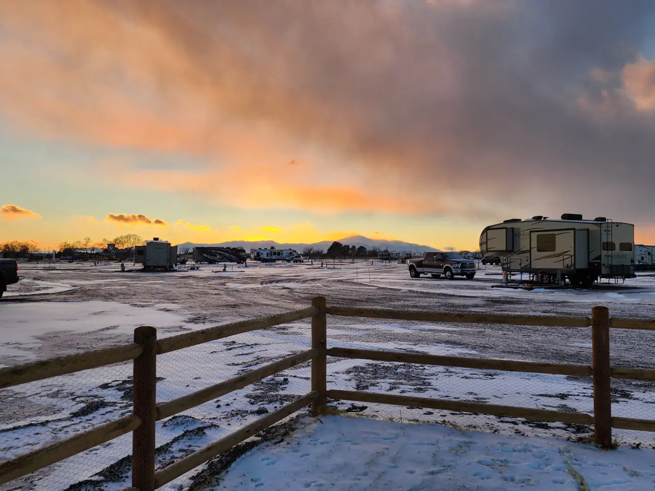 Winter sunset over big-rig RV sites with Pikes Peak on the horizon